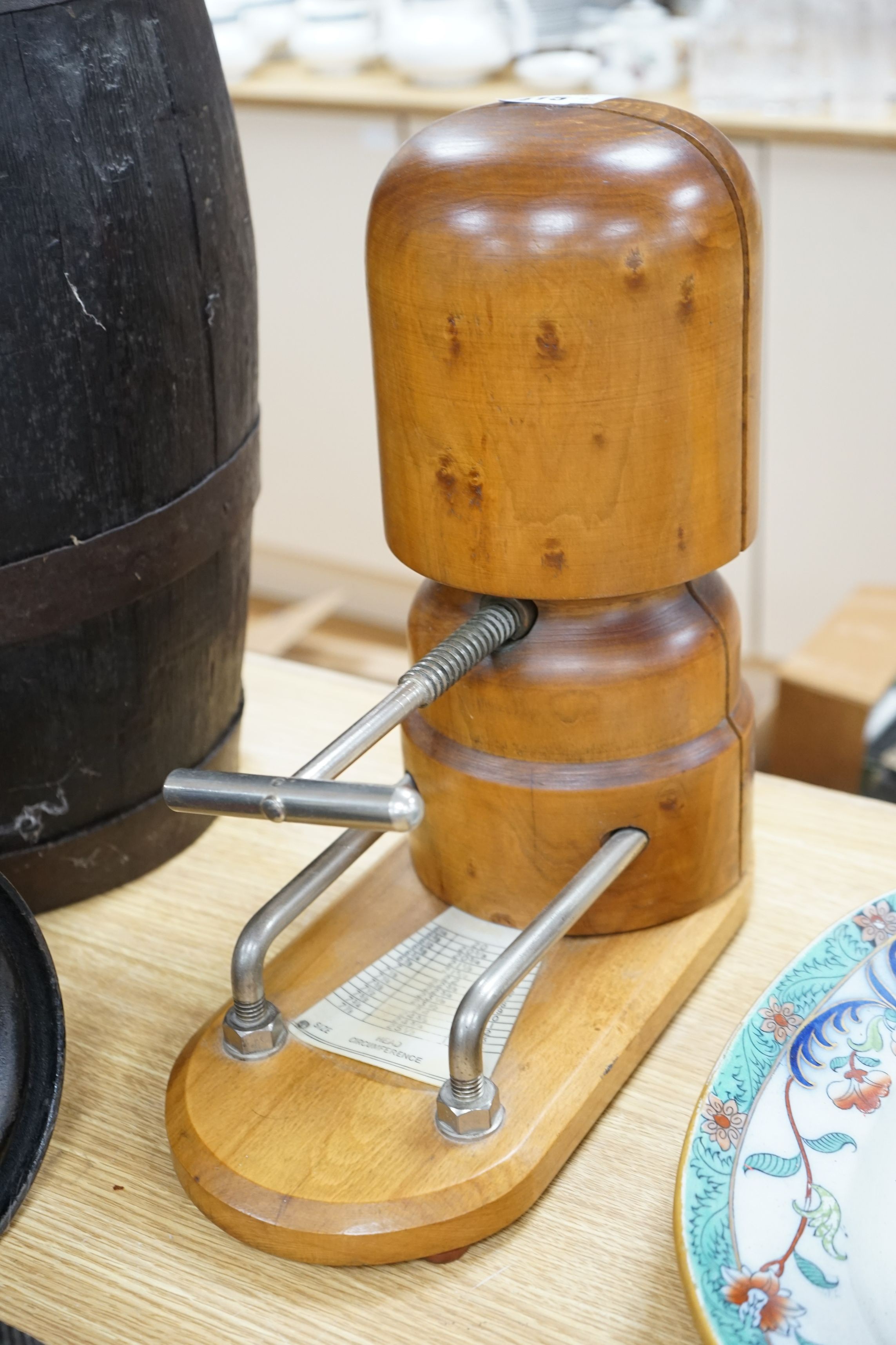 A wooden hat stretcher, 35cms high and a sock making machine